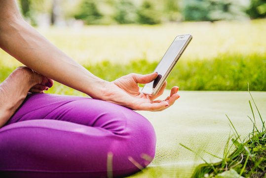 girl meditates with a phone in his hand
