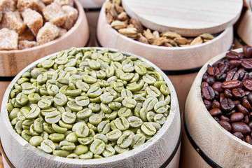 Coffee beans and coffee ingredients in wooden barrels