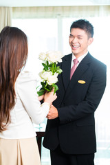 Asian Chinese hotel manager welcoming VIP guest