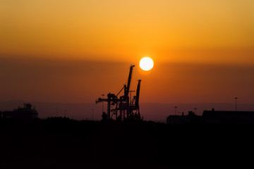 Industrial Sunset. Dock Container Crane Silhouette