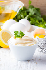Fresh homemade Mayonnaise and ingredients on white background