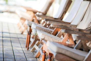 Beach chairs at beautiful tropical resort in sunset