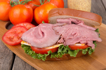 Roast Beef Sandwich With Tomatoes in Background