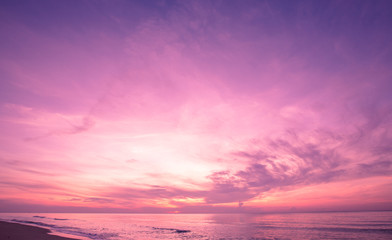 Naklejka na ściany i meble Beautiful sunrise sky on tropical beach. purple filter
