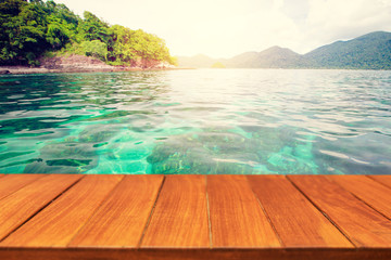 Fototapeta premium Wood table top on beautiful tropical sea background. For display and montage products