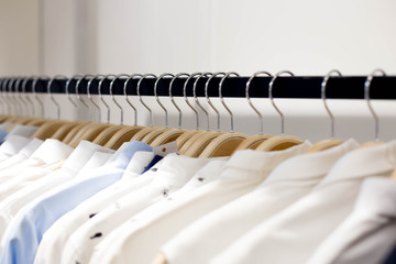 Clothes hang on a shelf in a designer clothes store