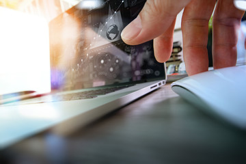 close up of business man hand working on laptop computer with di