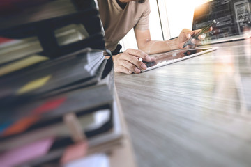 designer hand working with digital tablet and laptop computer an