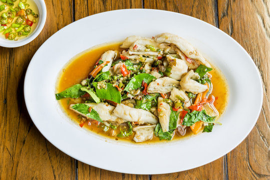Hot and spicy stir fried Sand whiting fish, Silver Sillago fish or Sillago maculata with Thai herb delicious food.
