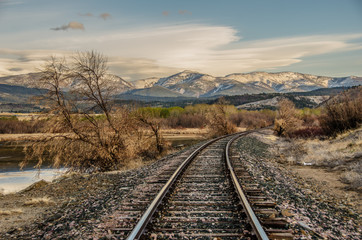 Fototapeta na wymiar Curve in the Tracks as they head towards the mountains