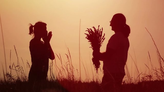 Slow motion video - man gives flowers to a woman. Full HD people stock footage.  
