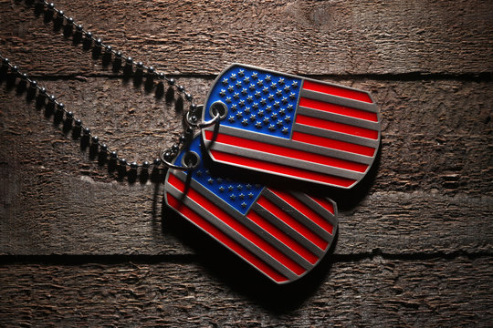 USA dog tags on wooden background