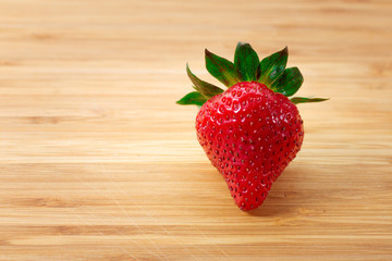 Ripe red strawberries on wooden table
