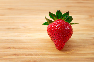 Ripe red strawberries on wooden table

