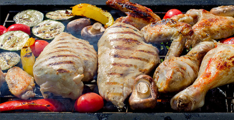 Grilled chicken breasts, wings and thighs with vegetables