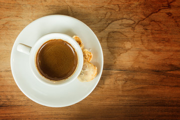 White cup of coffee on white brown table in cafe with copy space