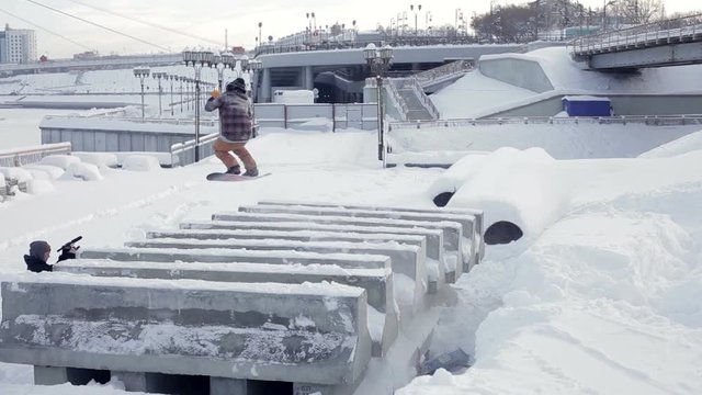 Snowboarder doing trick in the street