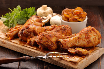 Roasted chicken legs with potato chips and vegetables