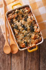 casserole with spinach and cheese close up in a dish. Vertical top view
