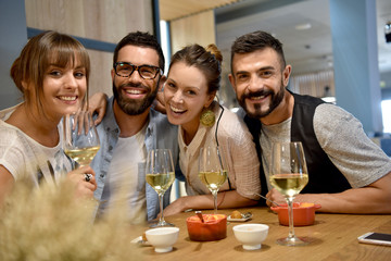 Portrait of friends in a bar drinking wine