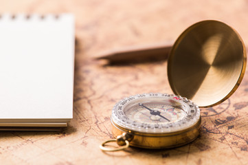 Compass on map and notepad