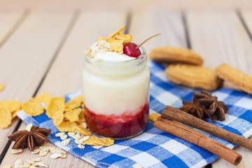 yogurt with cherry jam and oat flakes