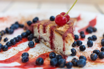 cherry pie with blueberries. on a plate with a wooden background