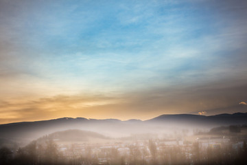 Summer landscape  with fog and the blue sky with sunset in mountains