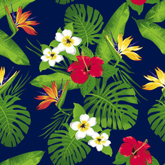 Tropical flowers and leaves on dark blue background. Seamless. Vector.