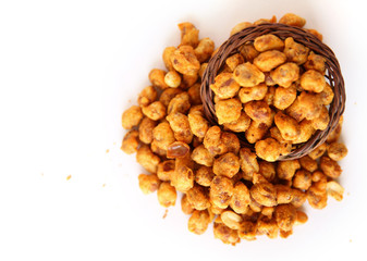 Spiced fried Peanuts oasted peanuts with wooden basket on white background