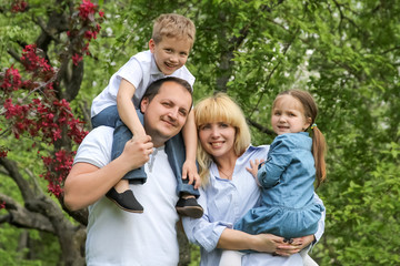 Happy family with two children in garden
