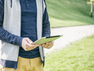 Man using digital Tablet Mockup walking in park