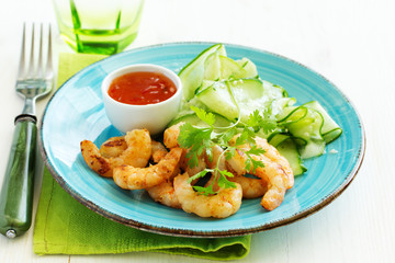 Salad with cucumber Asian style with fried shrimp.