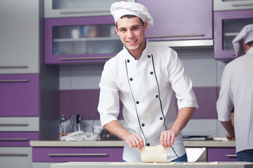 Vegetarian bakery concept. Smiling chef cook in uniform
