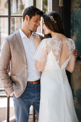 Naklejka premium Sensual smiling young couple of groom and bride