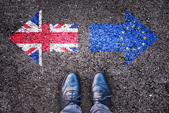 Brexit concept, deal or no deal, flags of the United Kingdom and  Europe on asphalt road with legs