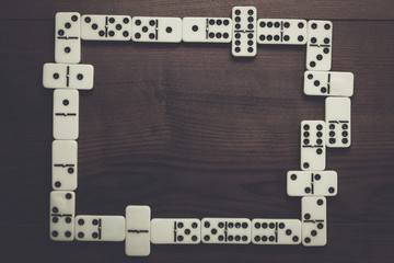 domino pieces on dark brown wooden background