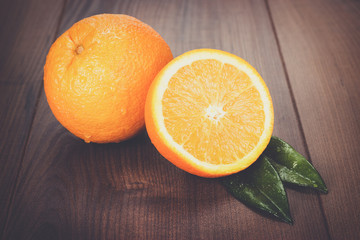 fresh oranges on the brown wooden table