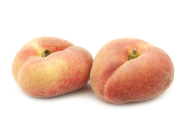 fresh colorful flat peaches (donut peaches) on a white background