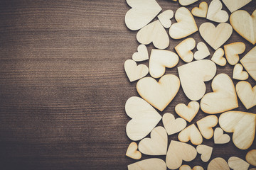Obraz na płótnie Canvas wooden heart shapes on the brown table