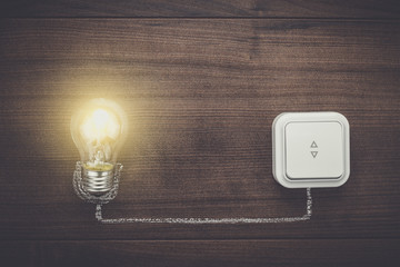 glowing bulb uniqueness concept on brown wooden background
