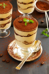 Traditional Italian dessert tiramisu in a glass.