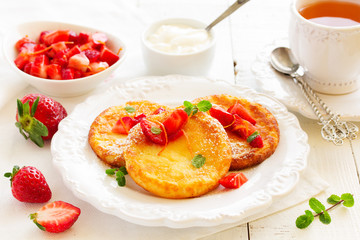 cottage cheese pancakes (cheese cakes) with strawberries and cream.