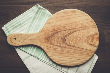 old cutting board and dishcloth on the wooden table