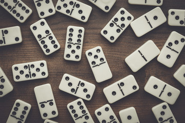 domino pieces on the brown wooden table background