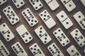 domino pieces on the brown wooden table with copy space