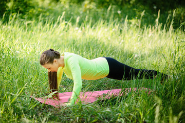 Woman exercising in park on beautiful day.