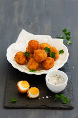 Quail eggs, deep fried with white sauce.