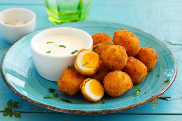 Quail eggs, deep fried with white sauce.