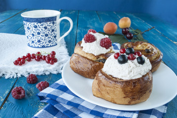 delicious breakfast with a cup of tea and cakes with fresh berries